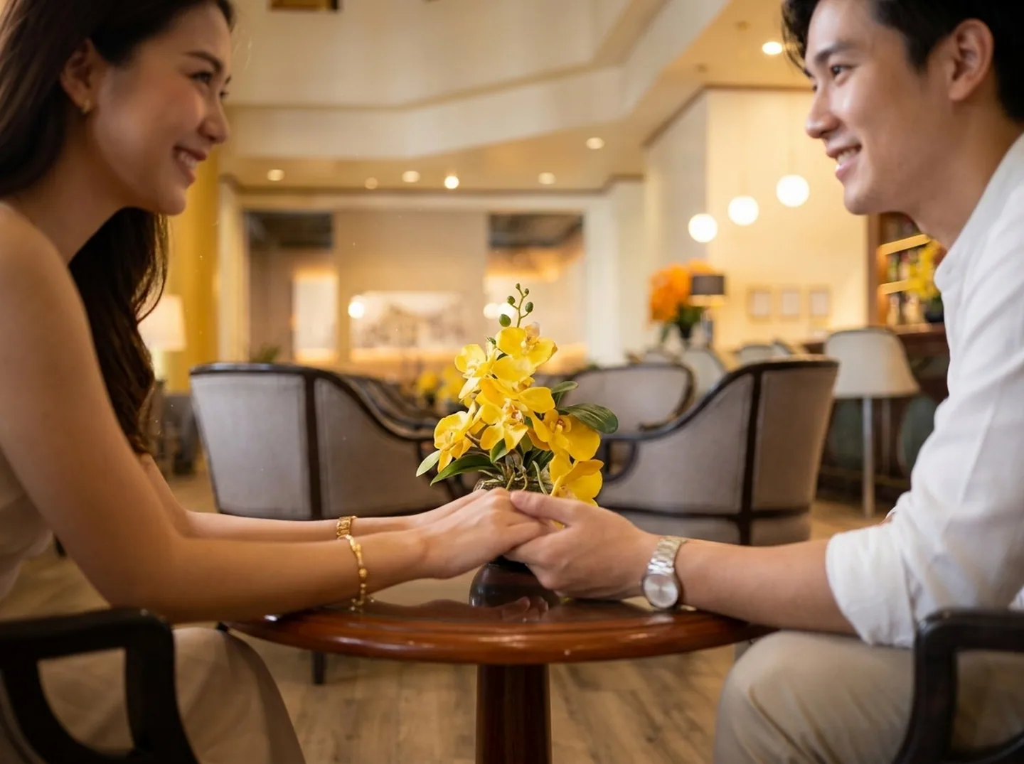 A couple sitting together at a hotel lobby lounge table