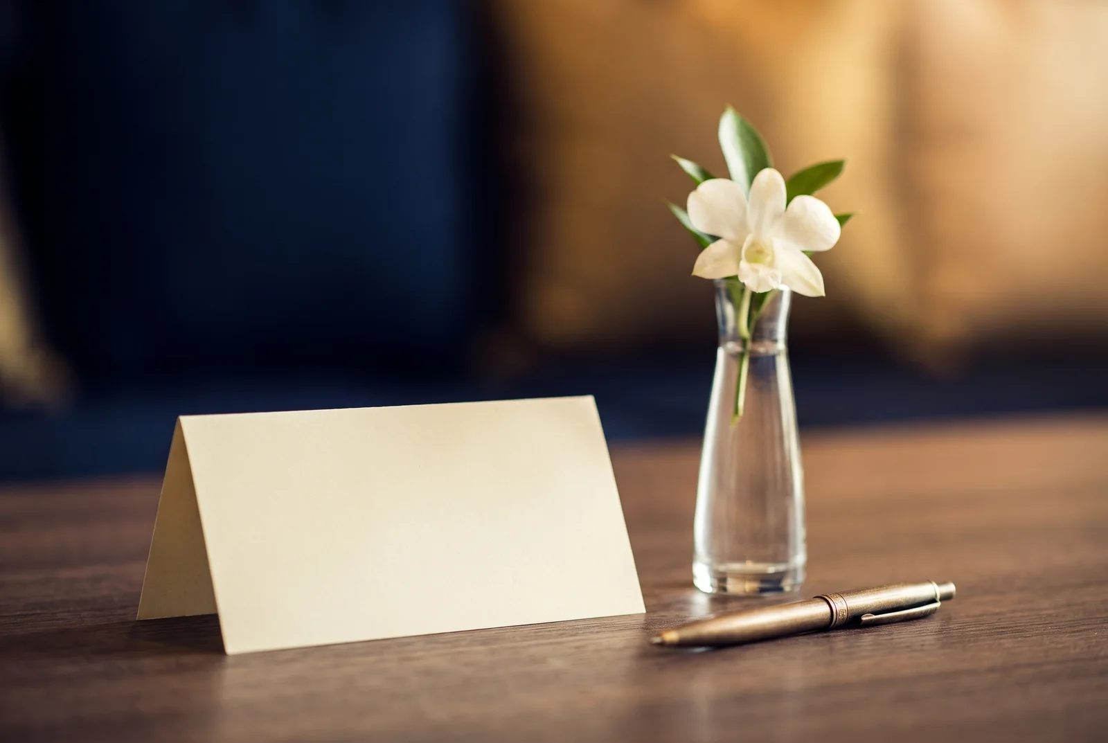 Blank table card, small flower vase and pen — AI-generated editorial illustration