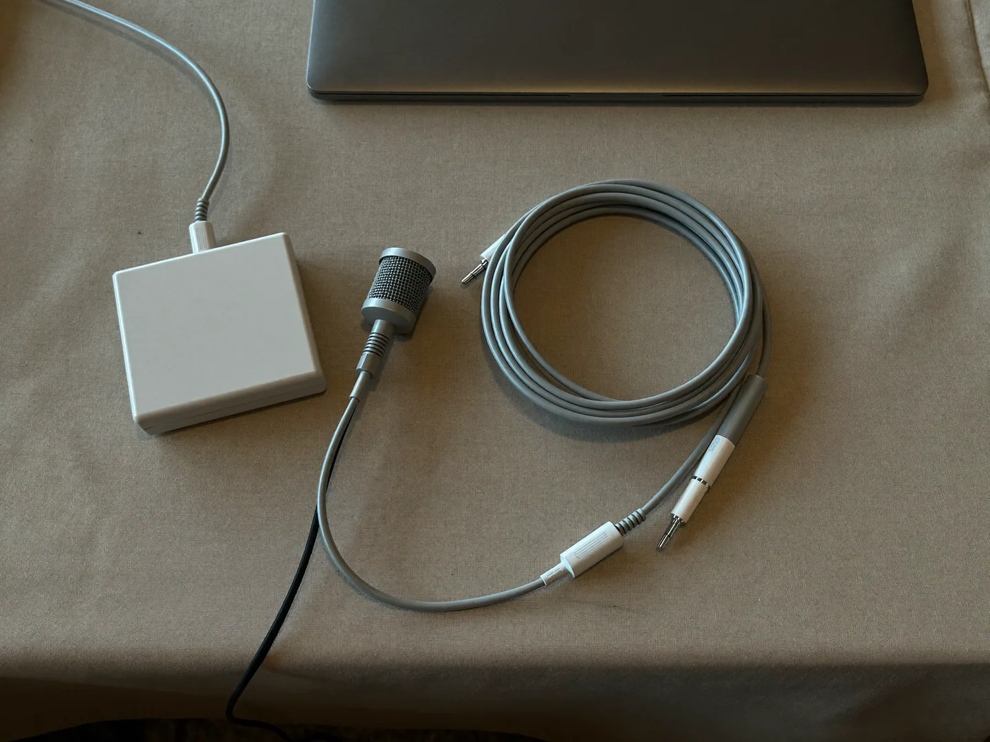 A generic presentation-planning kit with a microphone, cables and closed laptop