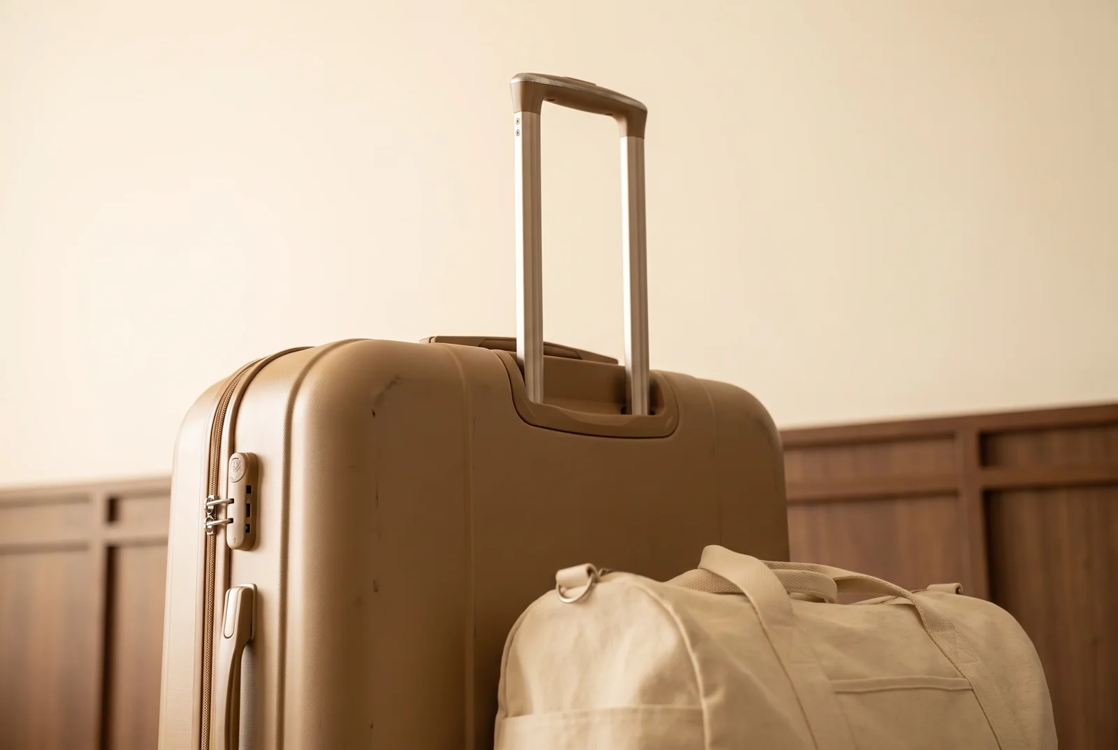 Tan suitcase and cream carry-on bag ready for a journey — AI-generated editorial illustration