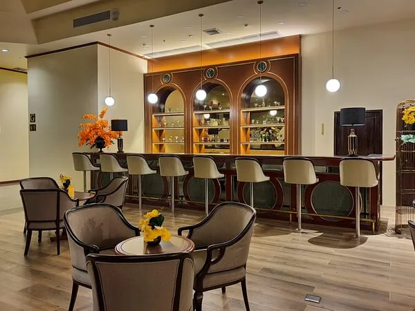 Tables and upholstered chairs facing the Atrium lounge bar