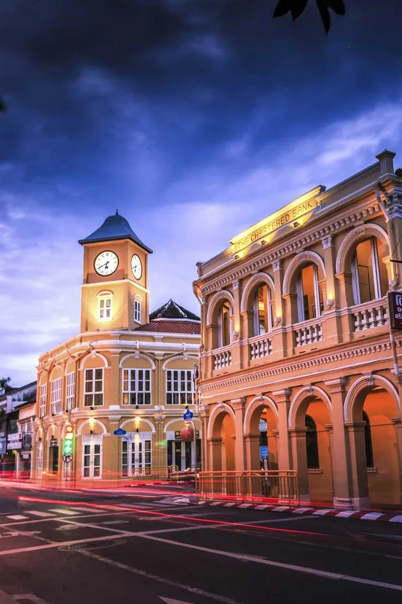 Phuket Town's historic clock tower and neighbouring heritage building at dusk