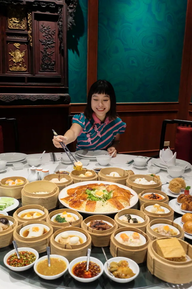 A diner seated at a restaurant table with several dishes