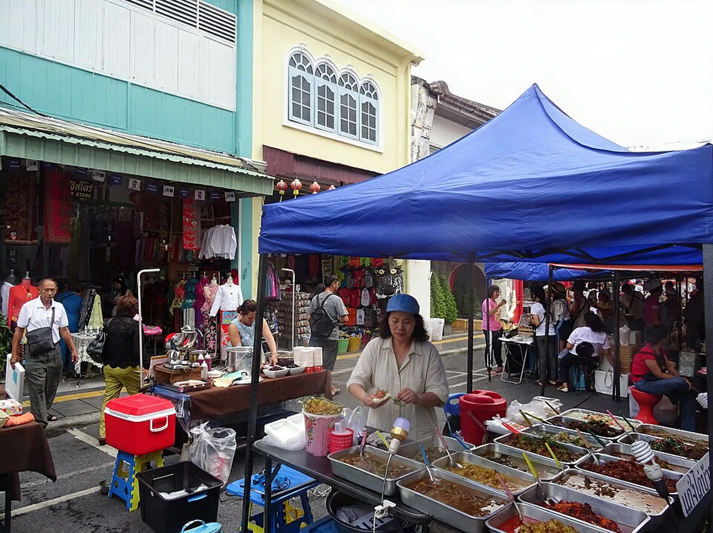 Blue-canopied food stall at the Thalang Road Sunday market in Phuket Old Town
