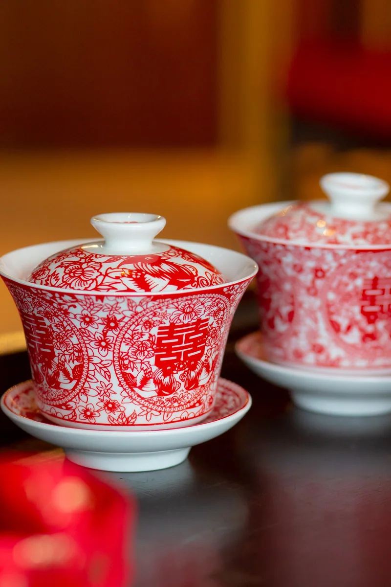 Red and white covered tea cups arranged on a table