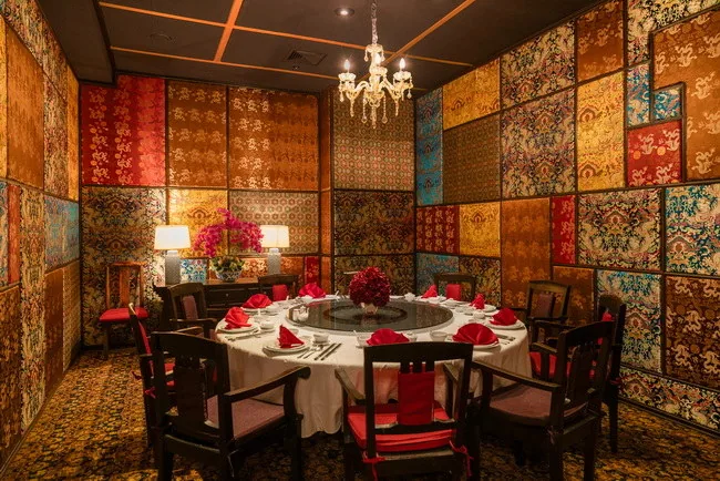 A restaurant table beside a window and decorative wall panels